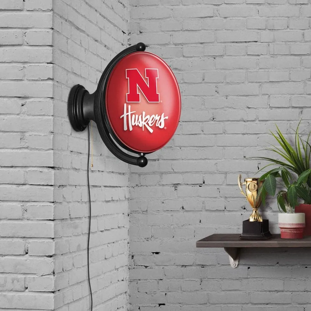 Nebraska Cornhuskers: Original Oval Rotating Lighted Wall Sign
