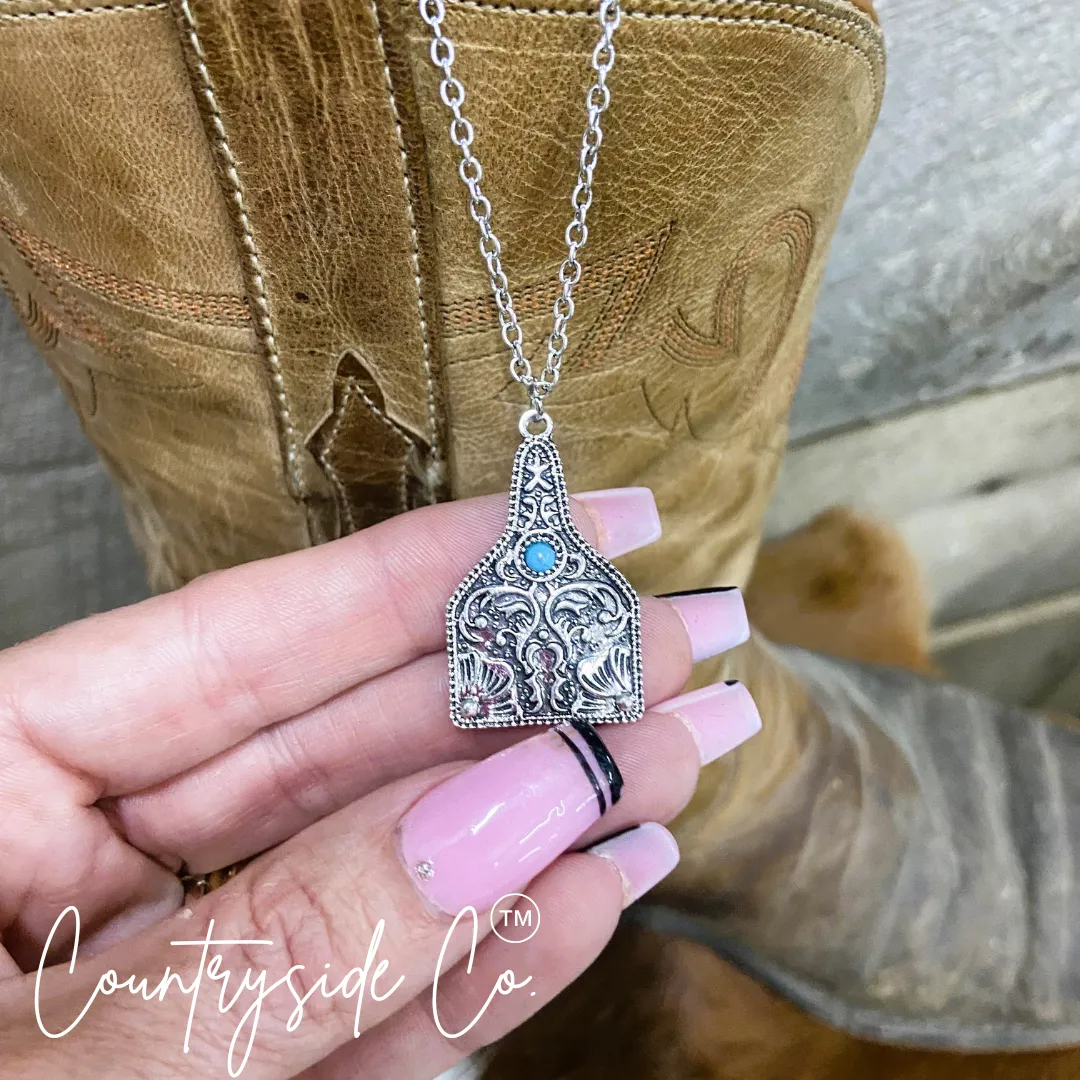 Tooled Silver & Turquoise Accent Cowtag Necklace